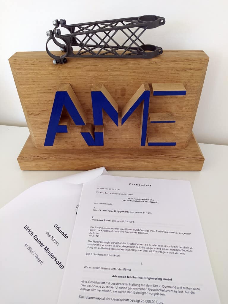 Logo der AME GmbH mit dem Notar Vertrag